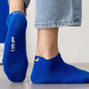 A close-up of blue breathable ankle boat socks with the text I see you all the time printed on the heel.
