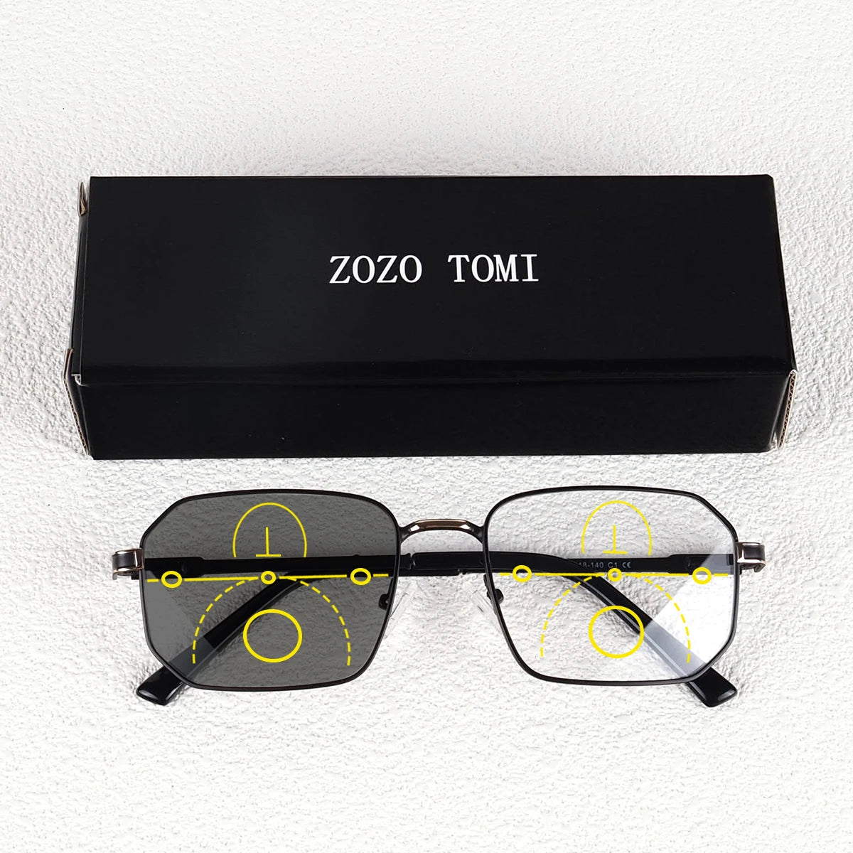 A pair of black photochromic progressive reading glasses are shown next to their original box labeled ZOZO TOMI.