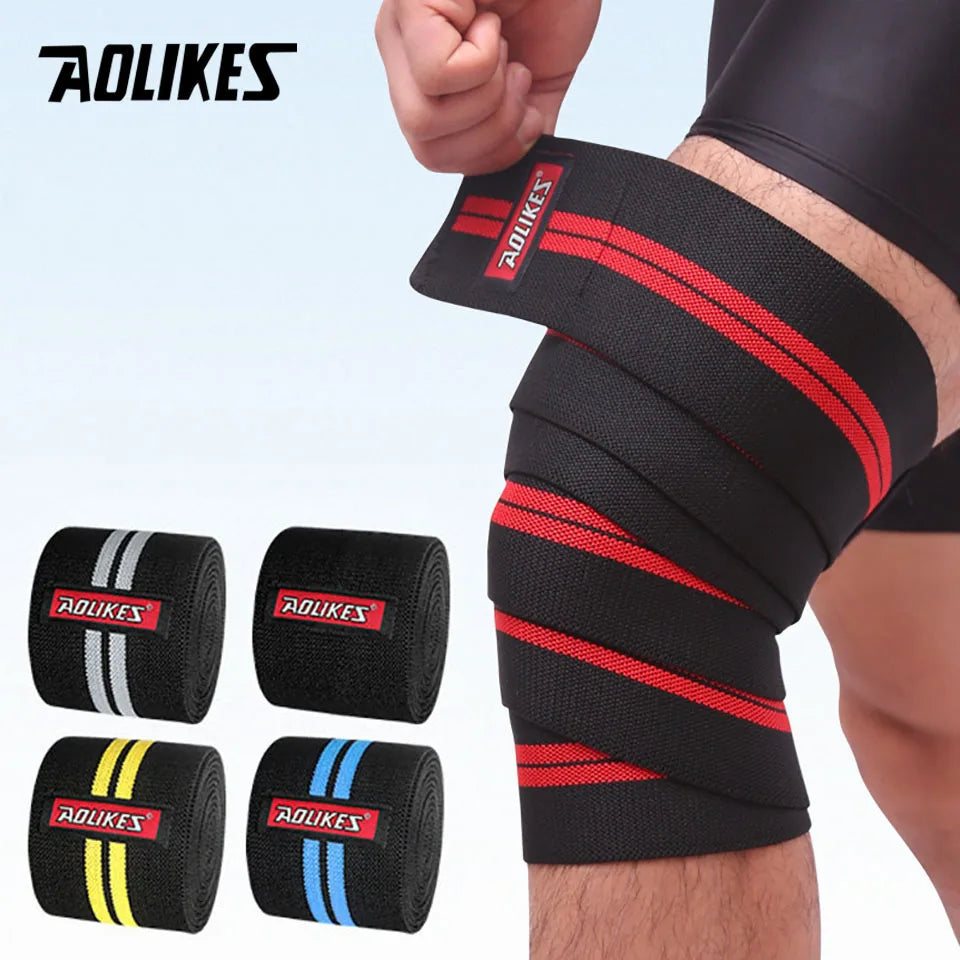 Black knee wraps with red and yellow stripes shown on a person's leg for weightlifting