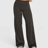 A pair of dark gray high waisted wide leg yoga pants being worn by a person.