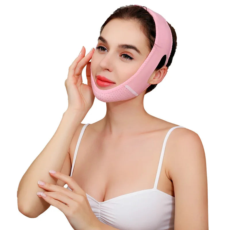 A woman is wearing a pink face slimming lifting strap designed for double chin treatment.