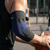 A person wearing a black compression sleeve on their forearm and elbow while playing basketball.