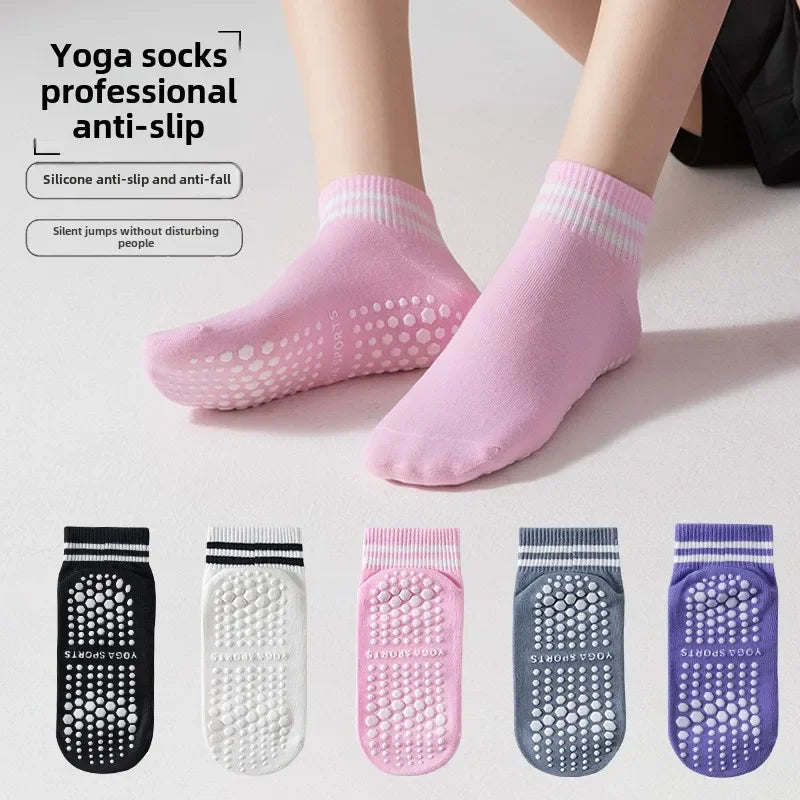 A set of pink yoga socks with silicone anti-slip grips shown on a person's foot.
