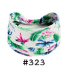 A floral patterned cotton headband tied in a knot, featuring green and pink leaves and blue flowers.