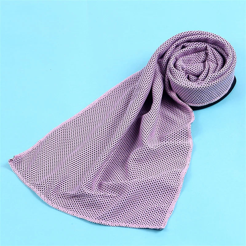 A lavender microfiber cooling towel is rolled up on a light blue background.