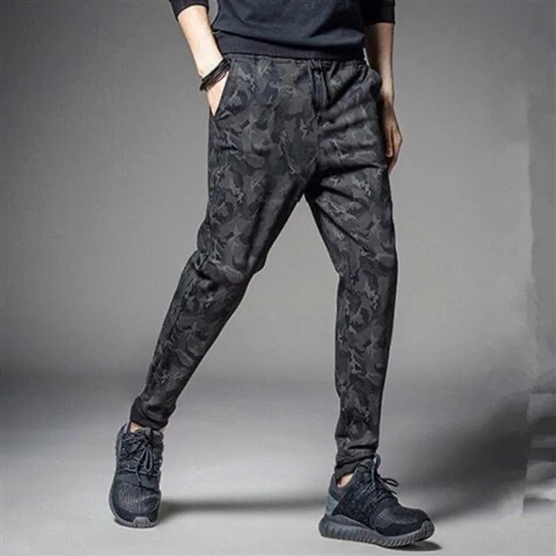 Men's camouflage elastic waist drawstring pants in dark gray fabric shown on a model.