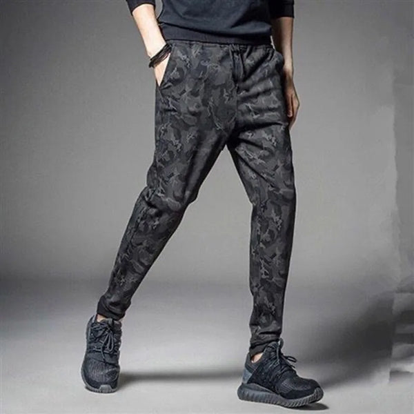 Men's camouflage elastic waist drawstring pants in dark gray fabric shown on a model.