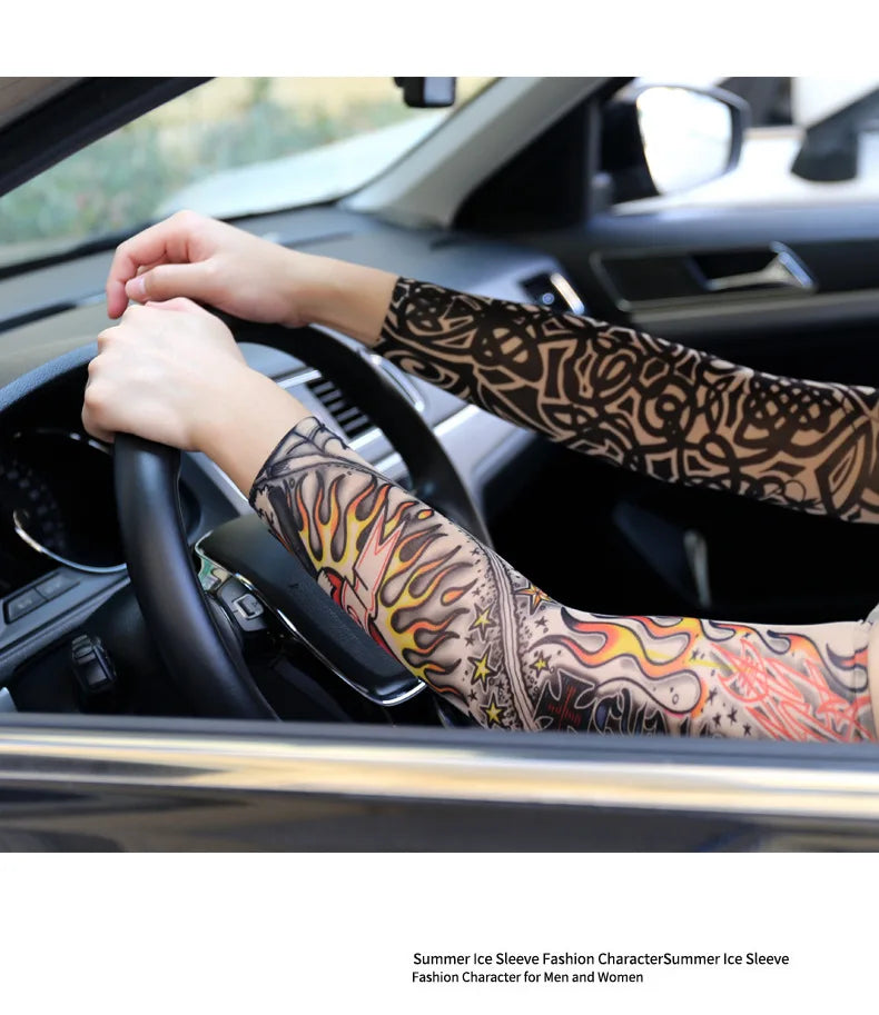 A person is driving a car with patterned arm sleeves visible on their hands and arms.