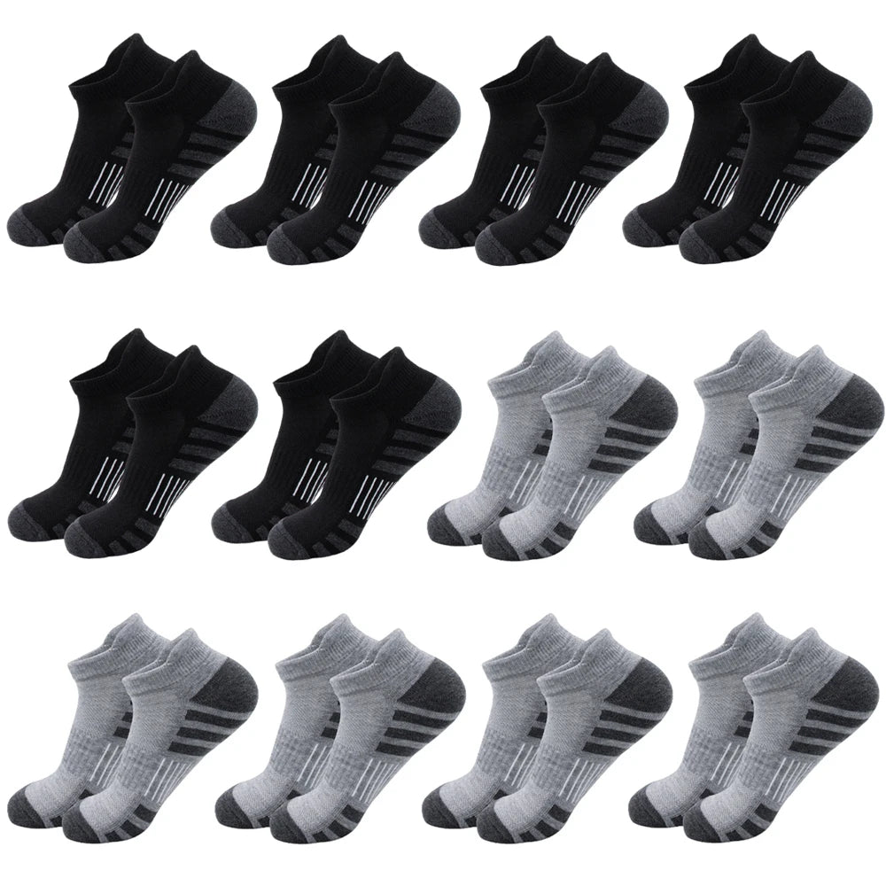 A collection of black and gray athletic running socks for men and women displayed in various folds.