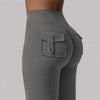 A close-up of a gray high stretch women's yoga legging featuring a front pocket detail.