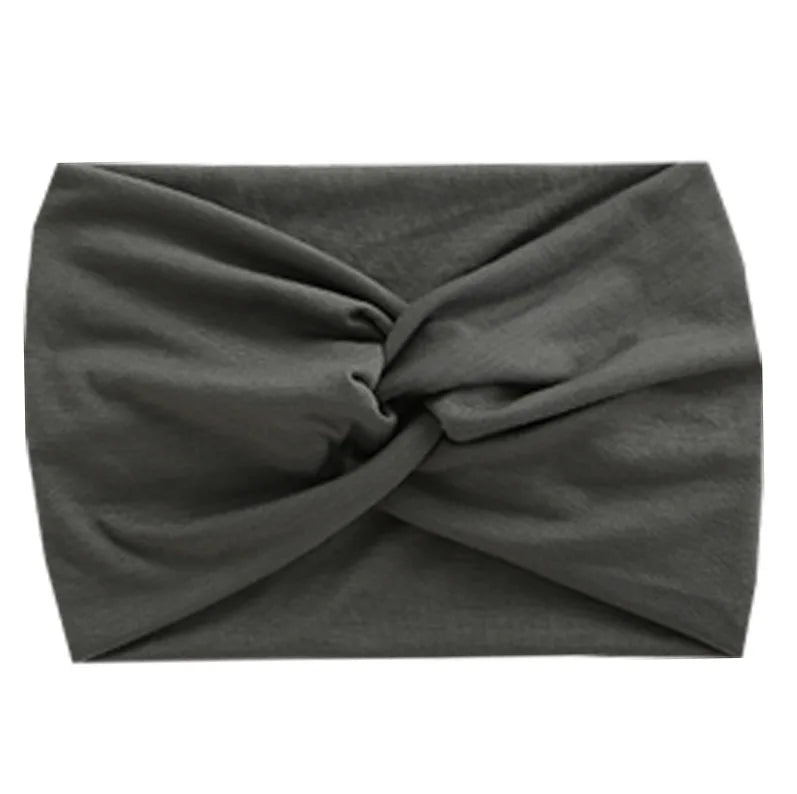 A dark gray women's elastic sports headband tied in a knot.