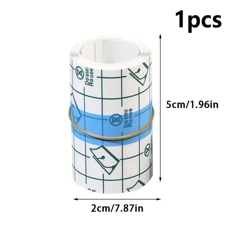 One roll of transparent self-adhesive finger protection tape with a white core and green markings.