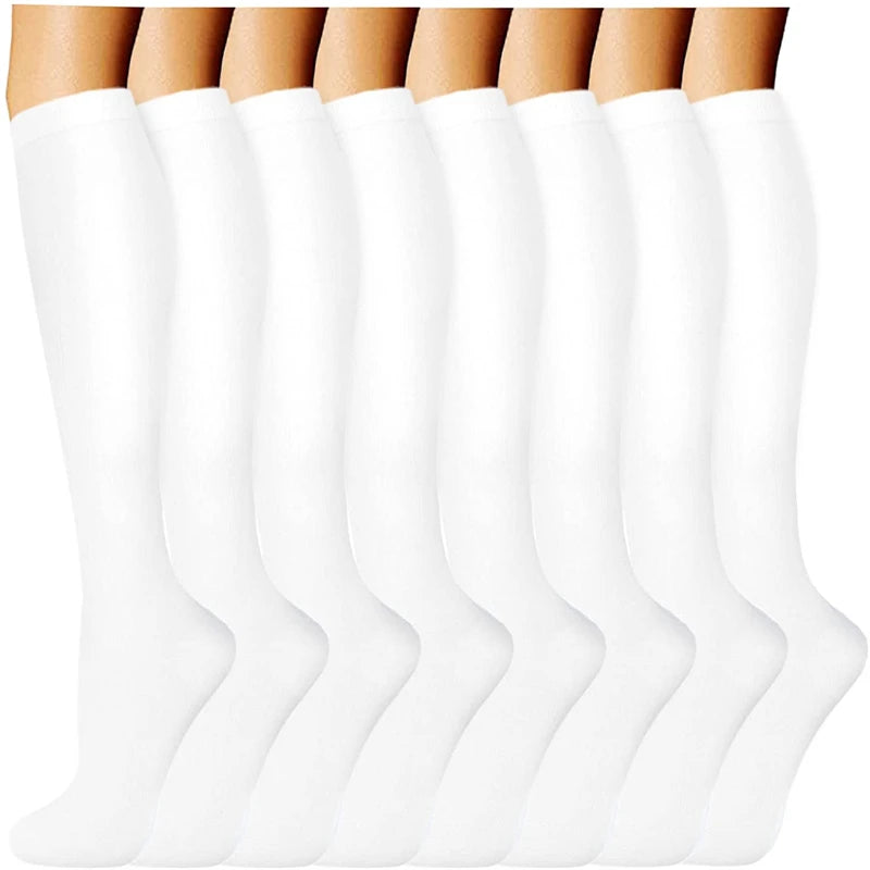 A row of white compression socks for vein support, shown from the leg down.