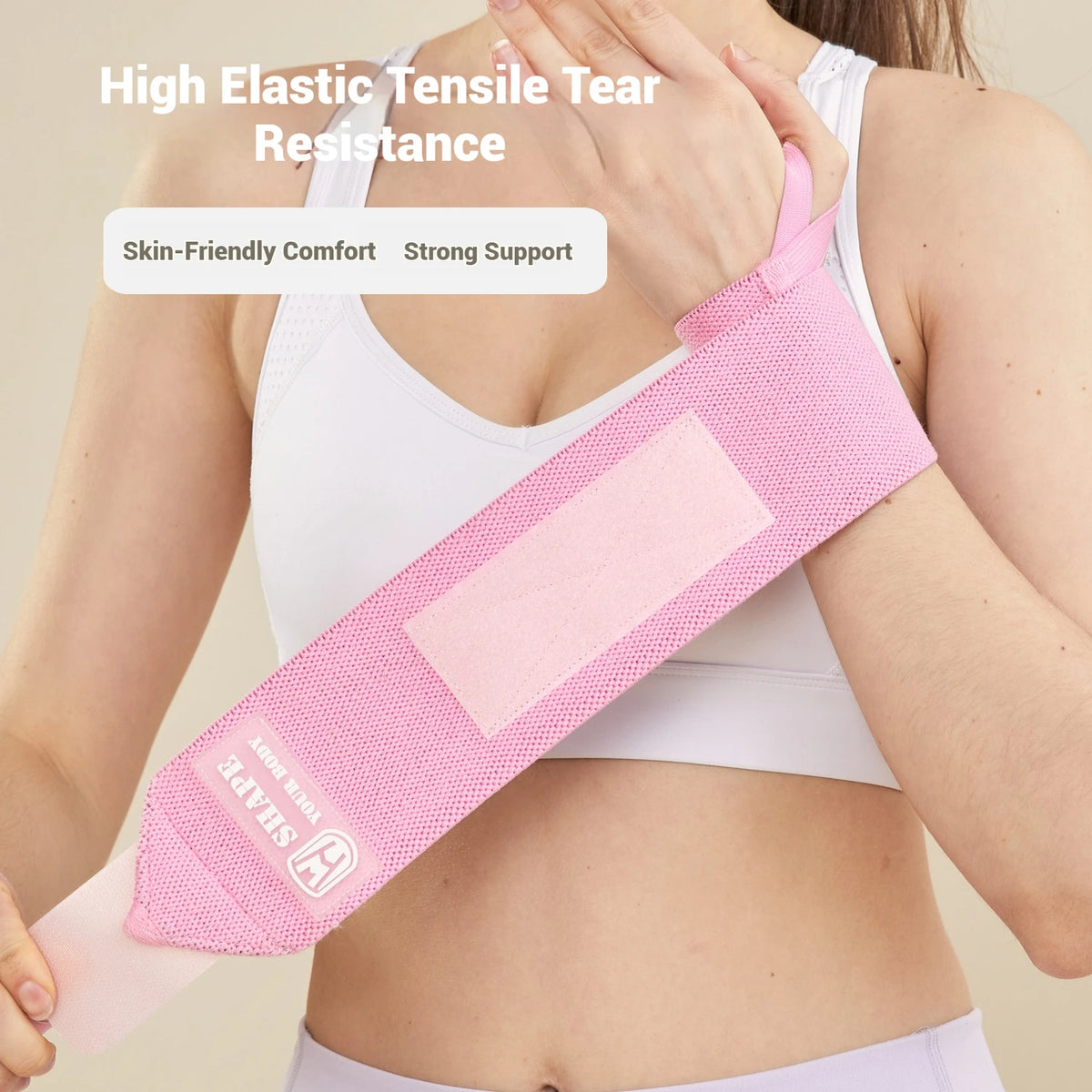 Pink elastic wrist guard bandage used for muscle support during fitness activities