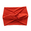 A folded orange women's elastic sports headband.