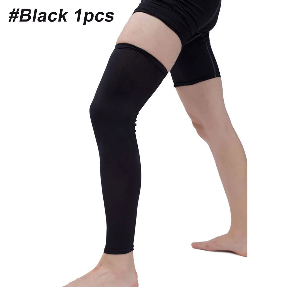 A person wearing black compression leg sleeves on their legs.