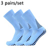 Three pairs of light blue performance football socks laid out for sale