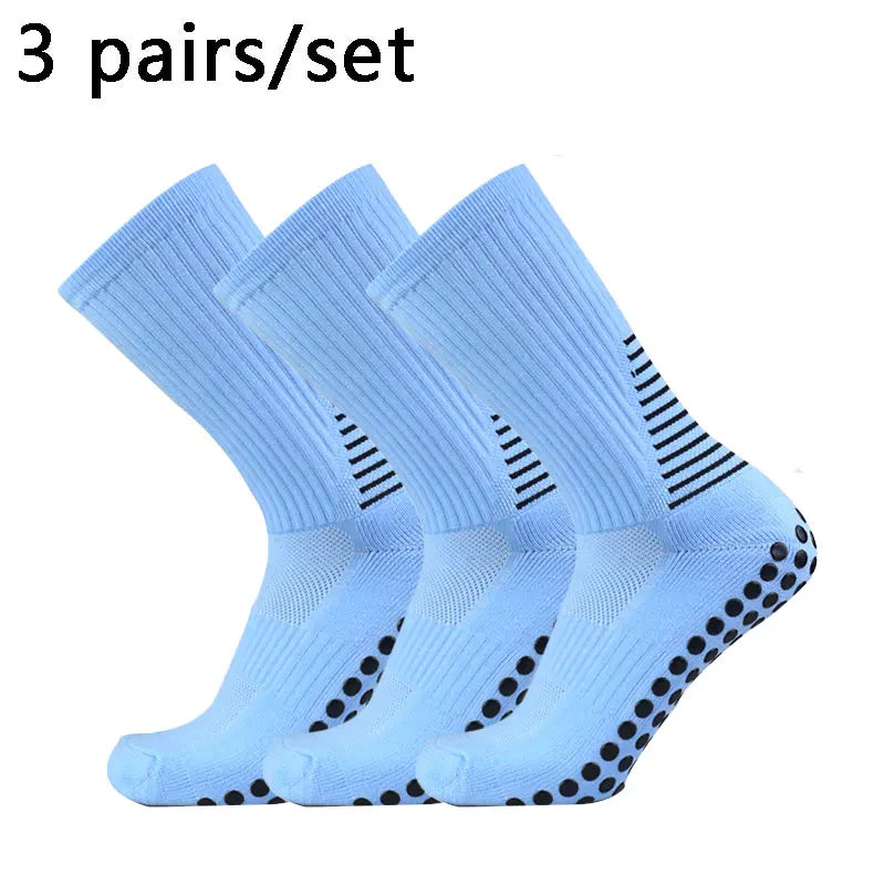 Three pairs of light blue performance football socks laid out for sale