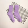 Purple mid-calf yoga and pilates socks with a ribbed texture and small silver dots