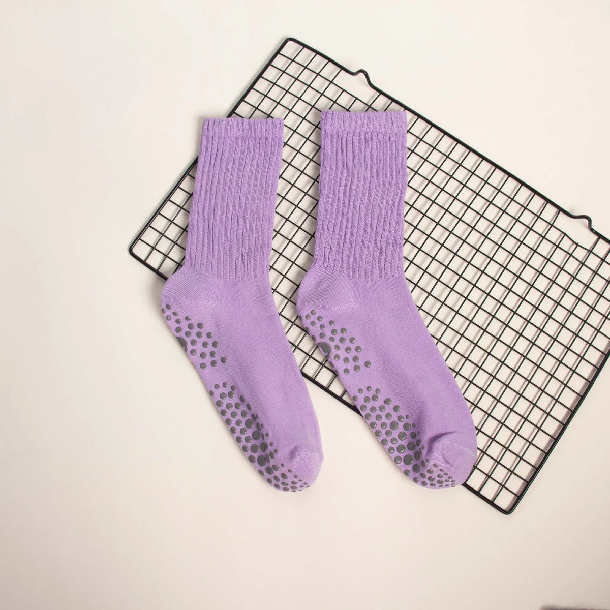 Purple mid-calf yoga and pilates socks with a ribbed texture and small silver dots