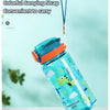 A clear dinosaur-themed silicone straw water bottle with a colorful carrying strap is held above it.