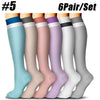 A set of six pairs of compression socks in various pastel colors and shades shown standing upright.