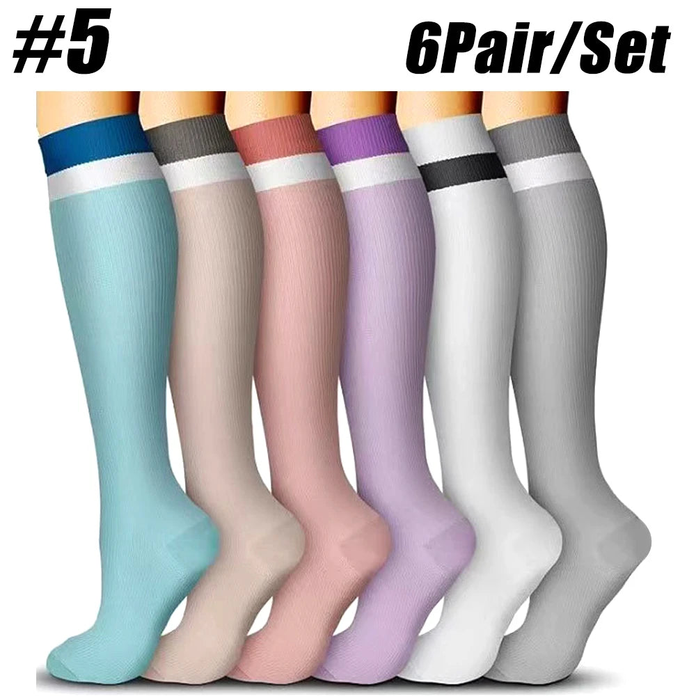 A set of six pairs of compression socks in various pastel colors and shades shown standing upright.