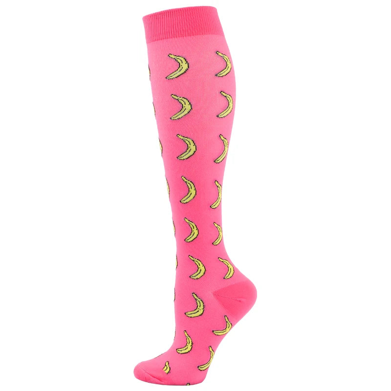 A pair of bright pink medical grade compression socks with yellow curved patterns.