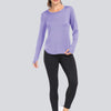 A woman models a purple long-sleeved loose fit sun protection t-shirt and black leggings.