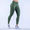 A person wearing olive green high-waisted seamless yoga leggings and light gray athletic shoes.