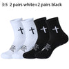 A collection of five pairs of white and five pairs of black prayer and cross grip sports socks.