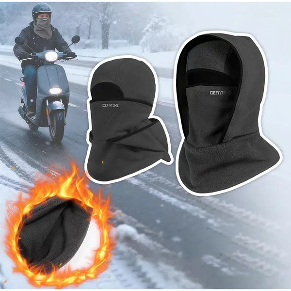 A black double-layer winter beanie is shown alongside a person riding a scooter in snowy conditions and a burning fire.