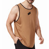 A man wearing a tan sleeveless sports tank top with black trim and a black logo on his upper body.
