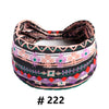 A patterned boho cotton turban headband featuring geometric designs in black, pink, purple, and green.