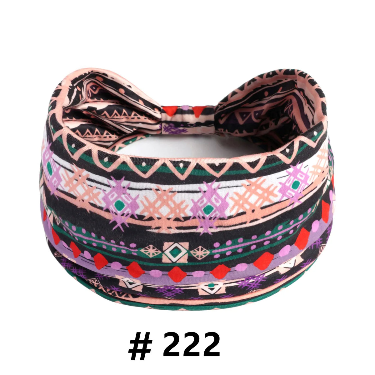 A patterned boho cotton turban headband featuring geometric designs in black, pink, purple, and green.