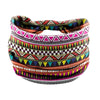 A colorful bohemian stretch cotton headband featuring geometric patterns in shades of pink, green, purple, and brown.