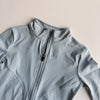 Light blue quick-dry yoga and fitness jacket shown in a close-up view