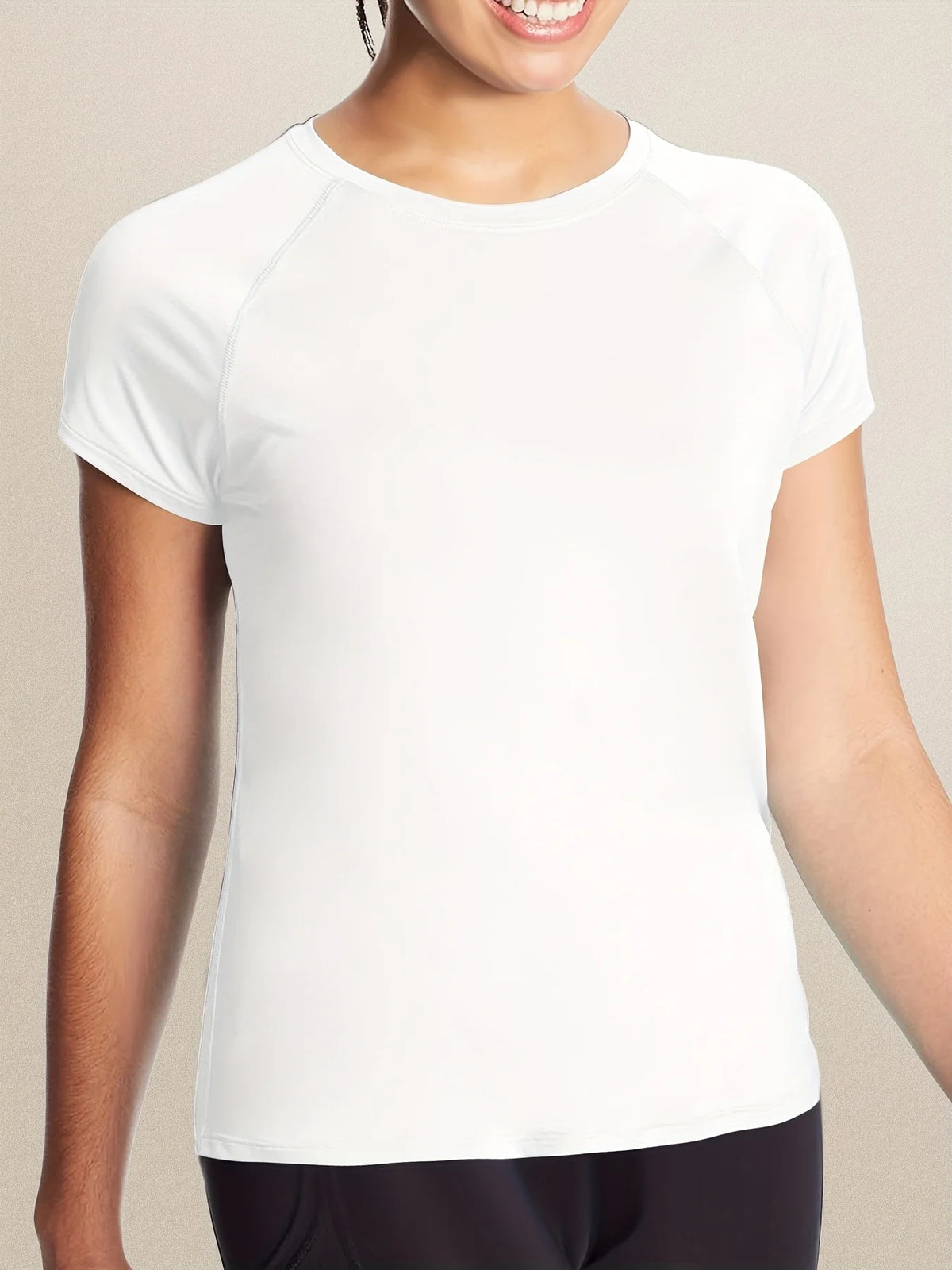 A white women's quick dry moisture-wicking gym t-shirt worn by a model.