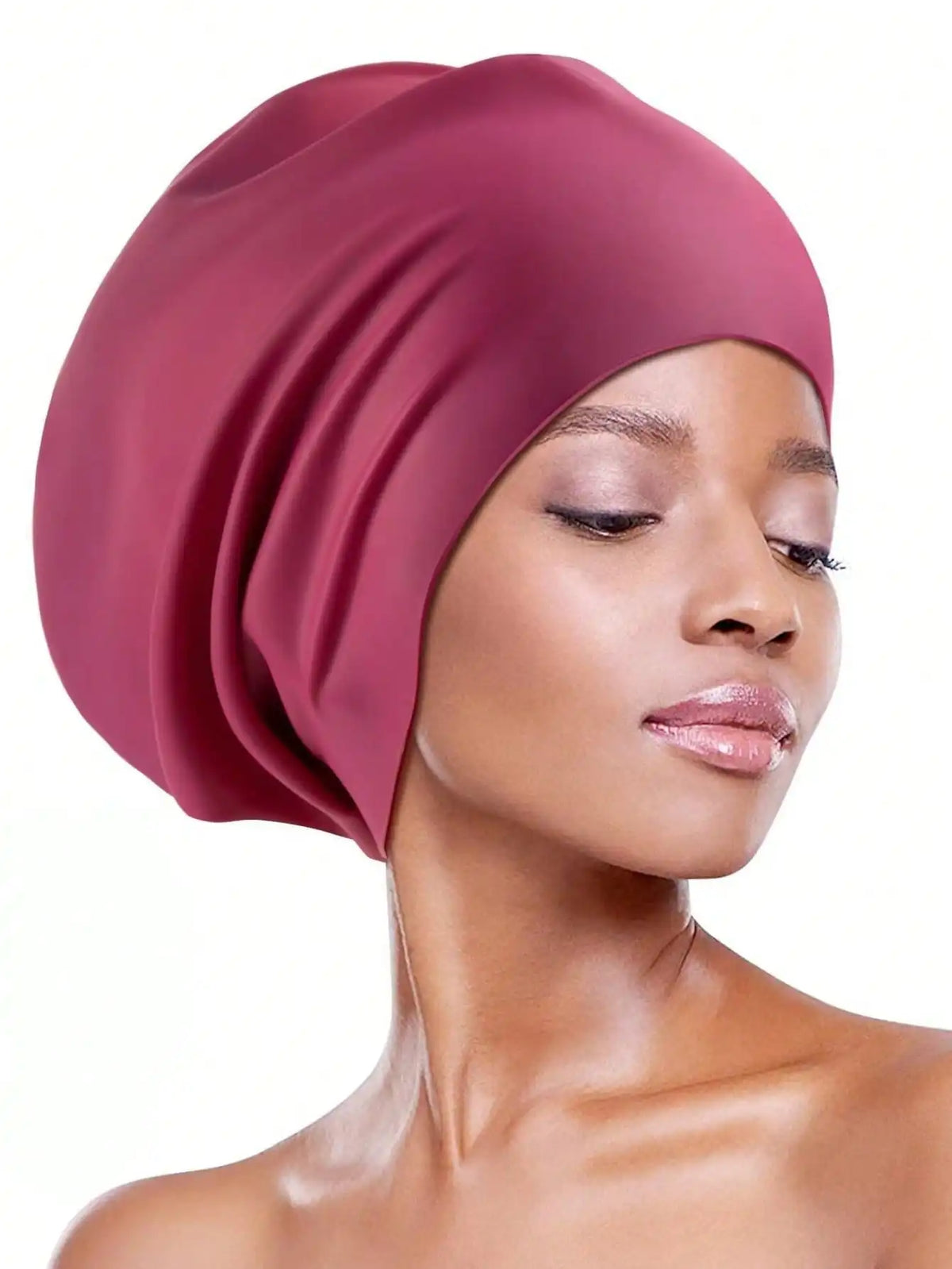 A model wearing a dusty rose silicone swim cap for long hair against a white background.