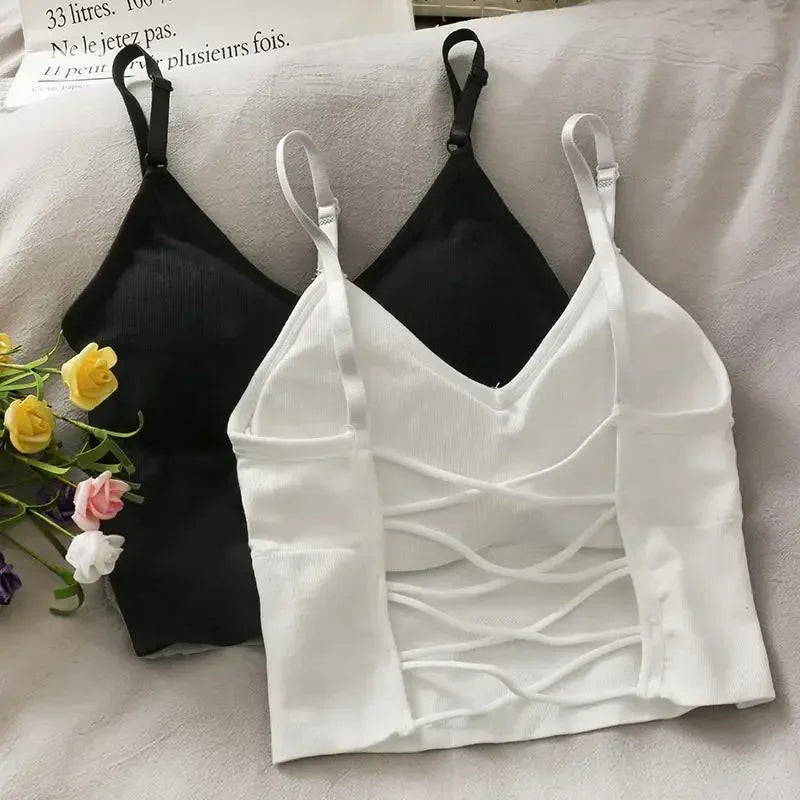 A white off-shoulder camisole tank top displayed next to a black version on a white surface.