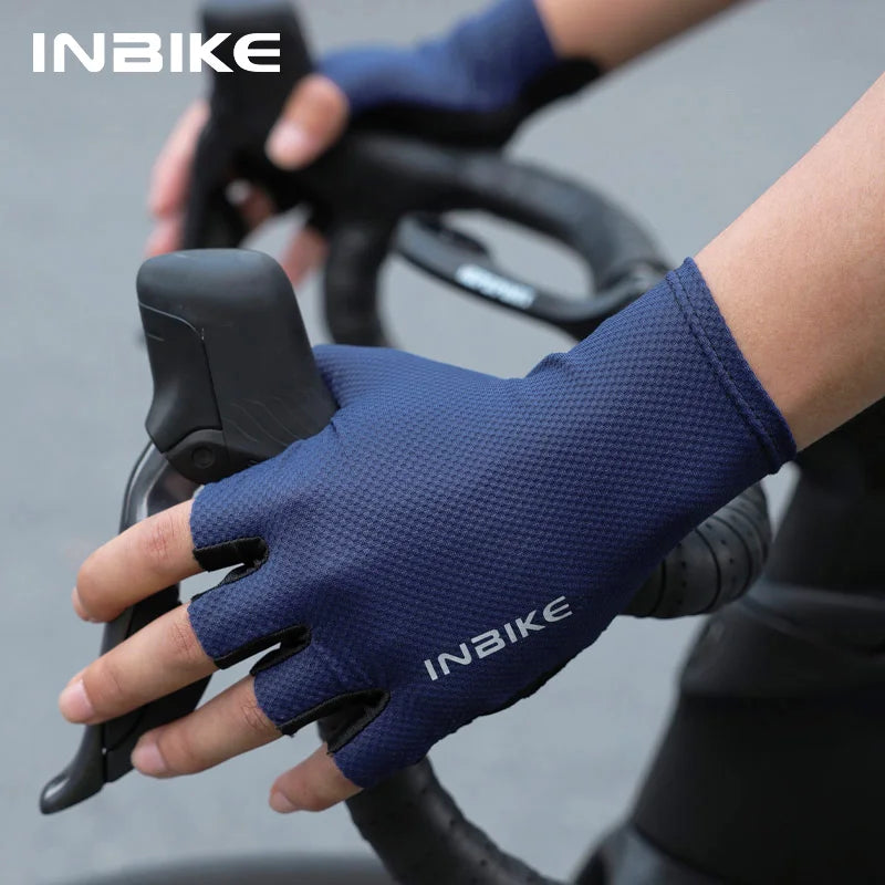 A hand wearing a navy blue half-finger cycling glove is gripping a bicycle handlebar.