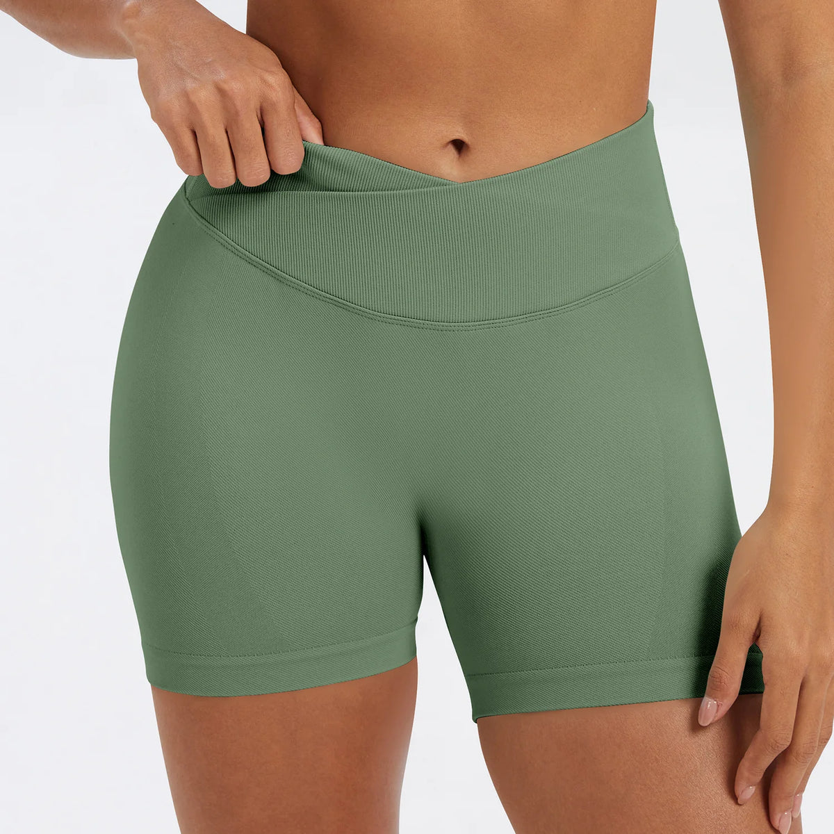 A model wearing olive green seamless high-waist yoga leggings.