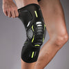 A black compression knee brace with neon yellow accents is worn on a person's leg.