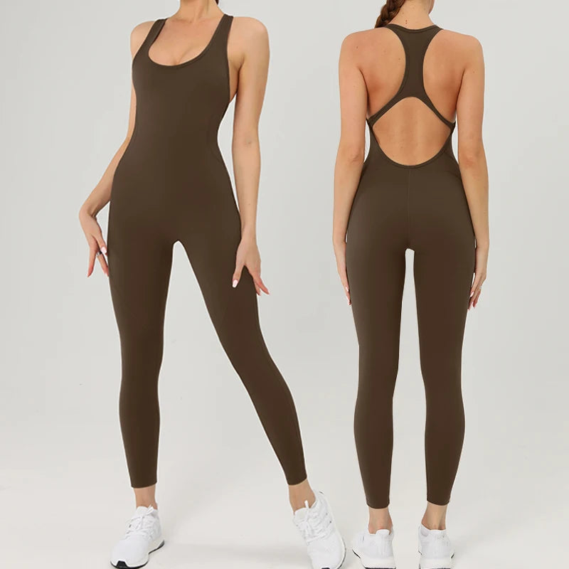 A woman models a dark olive green backless fitness jumpsuit.