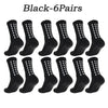 Six pairs of black athletic grip socks displayed in a row.