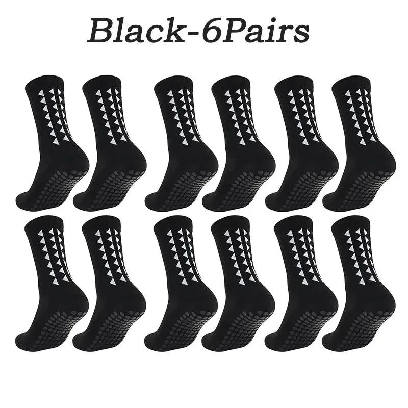 Six pairs of black athletic grip socks displayed in a row.