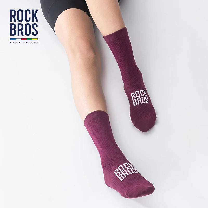 A pair of dark purple Rock Bros cycling socks worn on a person's leg.