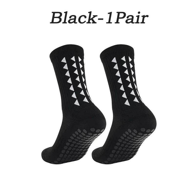 A pair of black multi-sport athletic grip socks shown from the side.