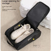 Black shoe carrier bag with a large opening for storage showing a pair of white athletic shoes inside