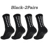 A set of five black athletic grip socks displayed individually.